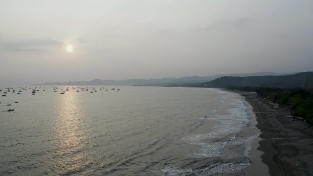 Sunset - Aerial 4K drone flying over Tropical Beach of Pelabuhan Ratu in Suka Bumi, West Java, Indonesia. Drone Videos on tropical beach