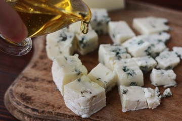 Blue mold cheese with honey on the table 