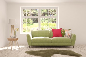 Stylish room in white color with sofa and summer landscape in window. Scandinavian interior design. 3D illustration