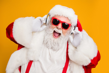 Close up photo of crazy funny santa claus listen music on modern headset celebrate christmas time...