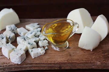 Blue mold cheese with honey on the table 