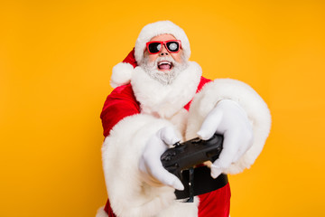 Portrait of funny funky crazy christmas father having x-mas newyear celebration play magic videogame use joy stick feel crazy wearing white gloves isolated over bright color background