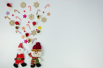 Fototapeta na wymiar Christmas background concept.Top view of santa claus and snowman splash out christmas decoration with candy cane, snowflake, star and colorful ball on white background with copy space for text.