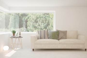 Stylish room in white color with sofa and summer landscape in window. Scandinavian interior design. 3D illustration