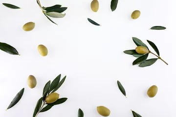 Fototapeten Frame or borders made of fresh green olive fruit with leaves on white background. Top view. © vetre