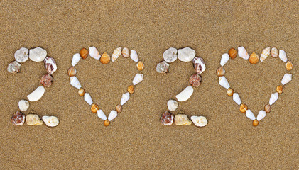 Fototapeta na wymiar Pebble New Year 2020 number with shell heart shape on wet sandy beach. Summer 2020 holidays concept. 