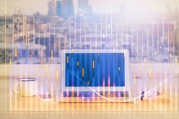 Financial graph colorful drawing and table with computer on background. Multi exposure. Concept of...