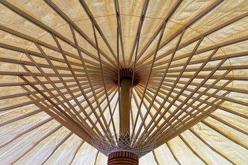 View inside traditional umbrella while open, Wooden frame and natural color mulberry paper, Traditional handicrafts of northern in thailand.