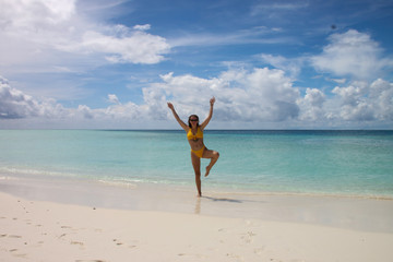 Girl doing yoga on paradise beach