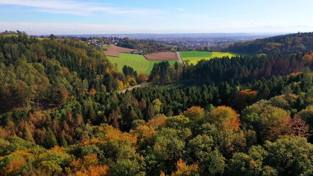 Aerial 4K footage over forest into village