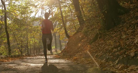 girl makes a run on the road. training. jogging. master shot. back view