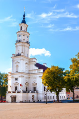 Town Hall, in Lithuanian Kauno Rotuse, on adjacent Town Hall Square in Kaunas, Lithuania photographed in the fall season with autumn trees. One of major tourist attractions of the city. Baltic states