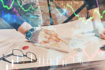 Multi exposure of man hands with stock market forex graph.