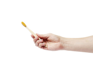 eco bamboo toothbrush in hand on white background