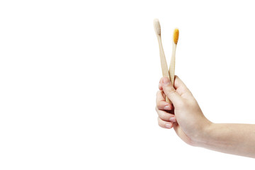 Two eco bamboo toothbrush in hand on white background