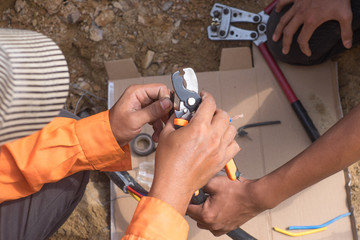 Electrical engineer technician fixing high voltage underground cable wire installation...