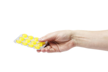 hand man holding color pills in blister pack on white background, close up