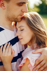 Couple in a field. Girl in a pink dress. Man in a white shirt