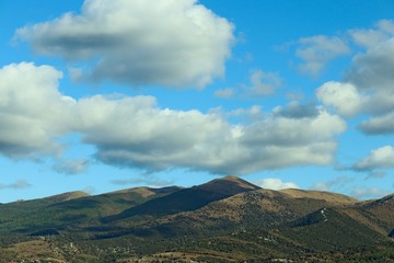 Obraz na płótnie Canvas Mountain landscape with white clouds