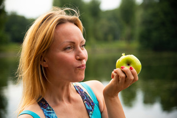 Beautiful girl eating green Apple