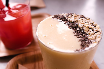 Healthy breakfast smoothie drink topped with oatmeal and sesame