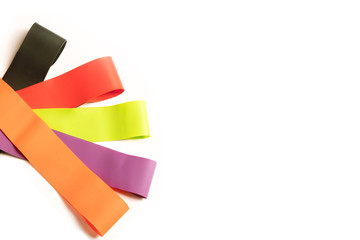 colorful latex rubber bands for fitness on white background. Elastic expanders for sports training isolated. Top view.