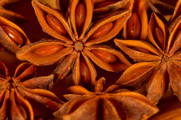 Christmas spice - Star anise on brown background, dry brown Anise star seeds, aromatic Asian spices ingredient in cooking, star anise background