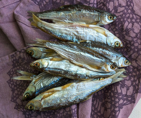 Salted dried river fish for beer on dark background