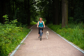 Girl on a bike ride with a dog