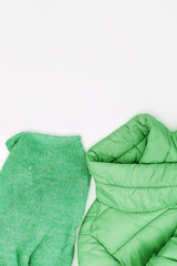 Female autumn set of clothing neo mint trend color, down jacket, warm wool knitted scarf. Shopping overview concept with copy space. Top view. Flat lay.
