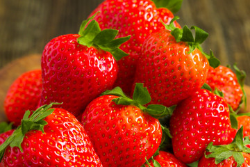 Strawberries in wooden bowl. Fresh nice strawberries on wooden table.