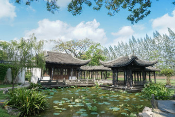 Chinese pavillion. A pavillion in ancient chinese architucture style by the water lily lake against the bright blue sky.