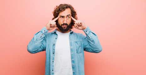young bearded crazy man feeling confused or doubting, concentrating on an idea, thinking hard,...