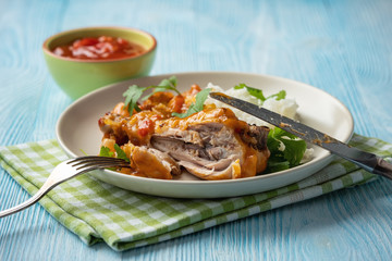Chicken drumstick in tomato sauce with boiled rice.