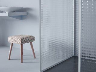 Small trendy stool located in middle of modern simple room with white wall and partition