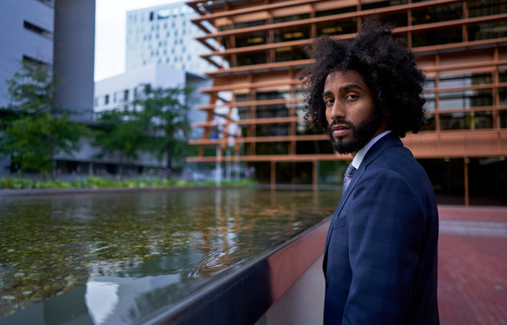 Ethnic businessman looking at camera