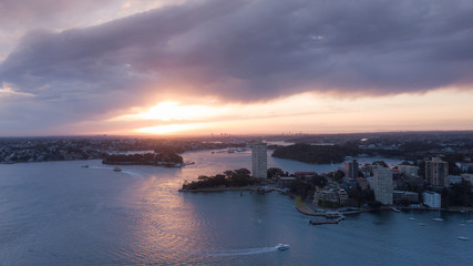 Aerial view of Sydney waterfront during golden hour sunset.