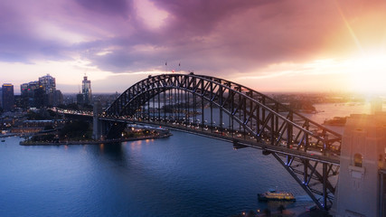 Aerial view of Sydney City during amazing golden sunset with Opera House and Harbour bridge in frame.Small amount of grain due to low light shot.All logotype removed.