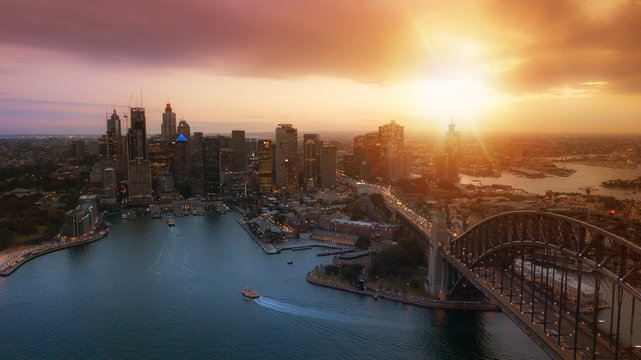 Aerial view of Sydney City during amazing golden sunset with Opera House and Harbour bridge in frame.Small amount of grain due to low light shot.All logotype removed.