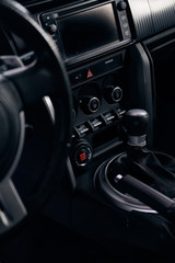 the dashboard and the gear lever of a sports car