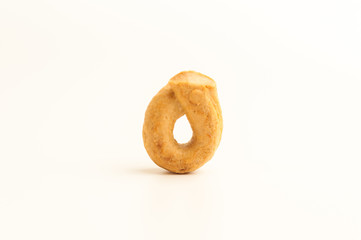 Taralli - a traditional Italian appetizer similar to drying or bagels, typical for the cuisine of Sicily and Calabria. Bagel on a white background, isolate. Copy space.