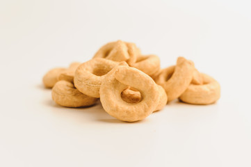 Taralli - a traditional Italian appetizer similar to drying or bagels, typical for the cuisine of Sicily and Calabria. Bagel on a white background, isolate. Copy space.