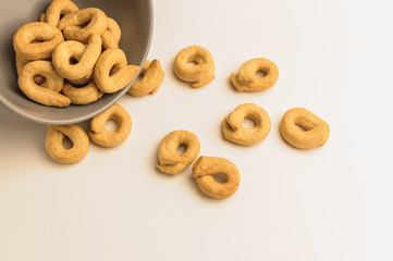 Taralli is a traditional Italian appetizer, similar to drying or bagels, typical of the cuisine of Sicily and Calabria. Bagel on a white background in a bowl.