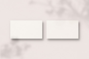 Blank business cards on pink background. Business card with soft shadows. Modern template for branding identity. Photo mockup with clipping path.