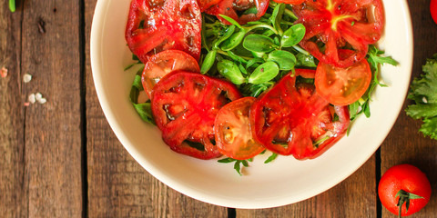 healthy salad tomatoes (vegetables, onions, greens, lettuce, sunflowers, microgreens and more) menu concept. food background. copy space. Top view