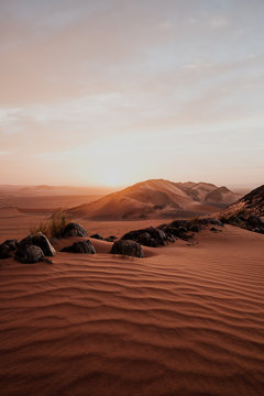 Cloudy sundown sky over hills and rocks in arid desert in evening in Morocco © Manuel Orts/ADDICTIVE STOCK