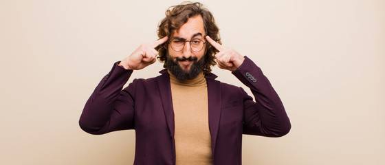 young bearded crazy man with a serious and concentrated look, brainstorming and thinking about a...