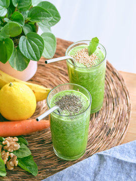 Set of ingredients for healthy smoothie and glasses with green drink