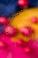 Soft focus abstract background with circles and balls. Bright yellow, red, pink and blue colors. Vertical format