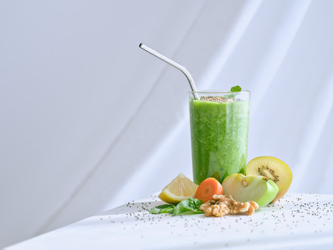 Set of ingredients for healthy smoothie and glass with green drink